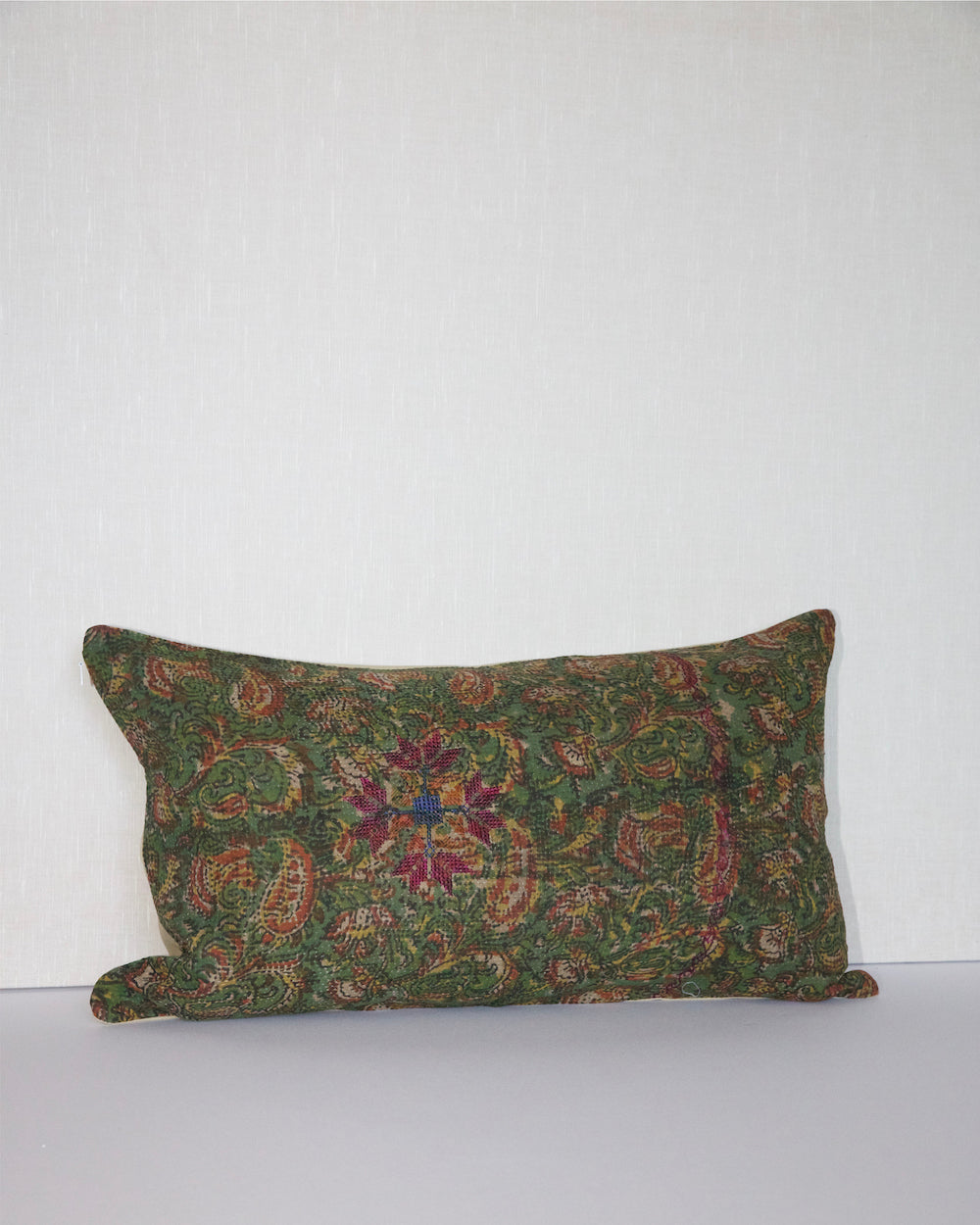 Handcrafted vintage Kantha pillow featuring a green floral block print design, adding bohemian and rustic charm to any room. The rectangular cushion is made from repurposed fabrics, reflecting traditional Indian craftsmanship