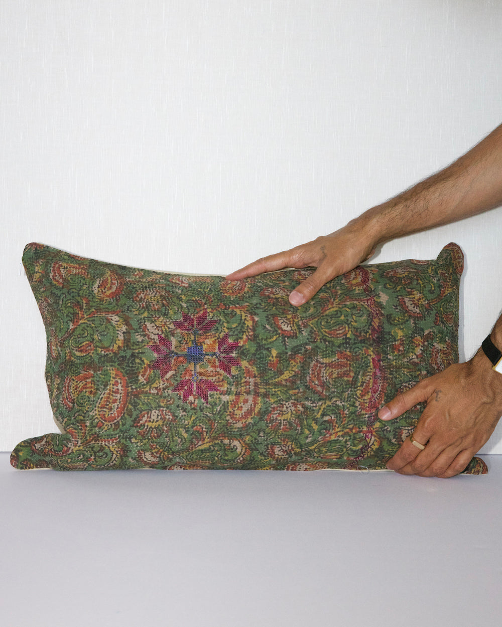Handcrafted vintage Kantha pillow featuring a green floral block print design, adding bohemian and rustic charm to any room. The rectangular cushion is made from repurposed fabrics, reflecting traditional Indian craftsmanship
