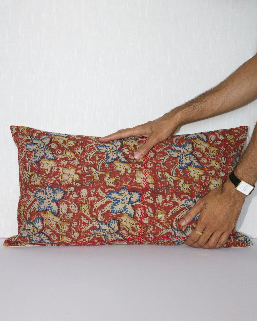 Handcrafted vintage Kantha pillow featuring a rust floral block print design, adding bohemian and rustic charm to any room. The rectangular cushion is made from repurposed fabrics, reflecting traditional Indian craftsmanship