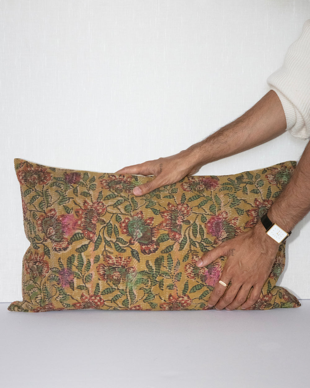 Handcrafted vintage Kantha pillow featuring a ochre and rust floral block print design, adding bohemian and rustic charm to any room. The rectangular cushion is made from repurposed fabrics, reflecting traditional Indian craftsmanship
