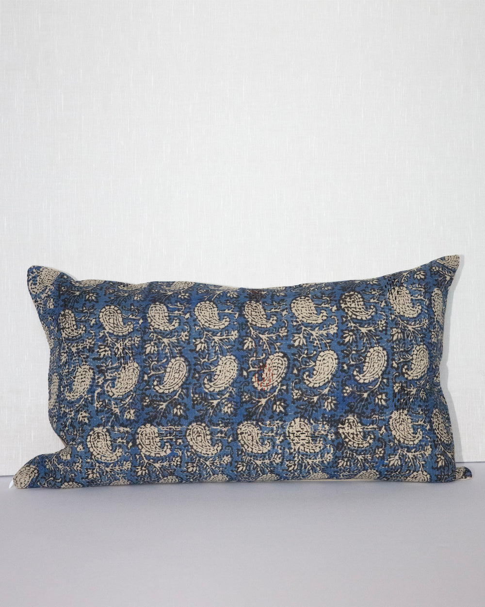 Handcrafted vintage Kantha pillow featuring a indigo paisley block print design, adding bohemian and rustic charm to any room. The rectangular cushion is made from repurposed fabrics, reflecting traditional Indian craftsmanship