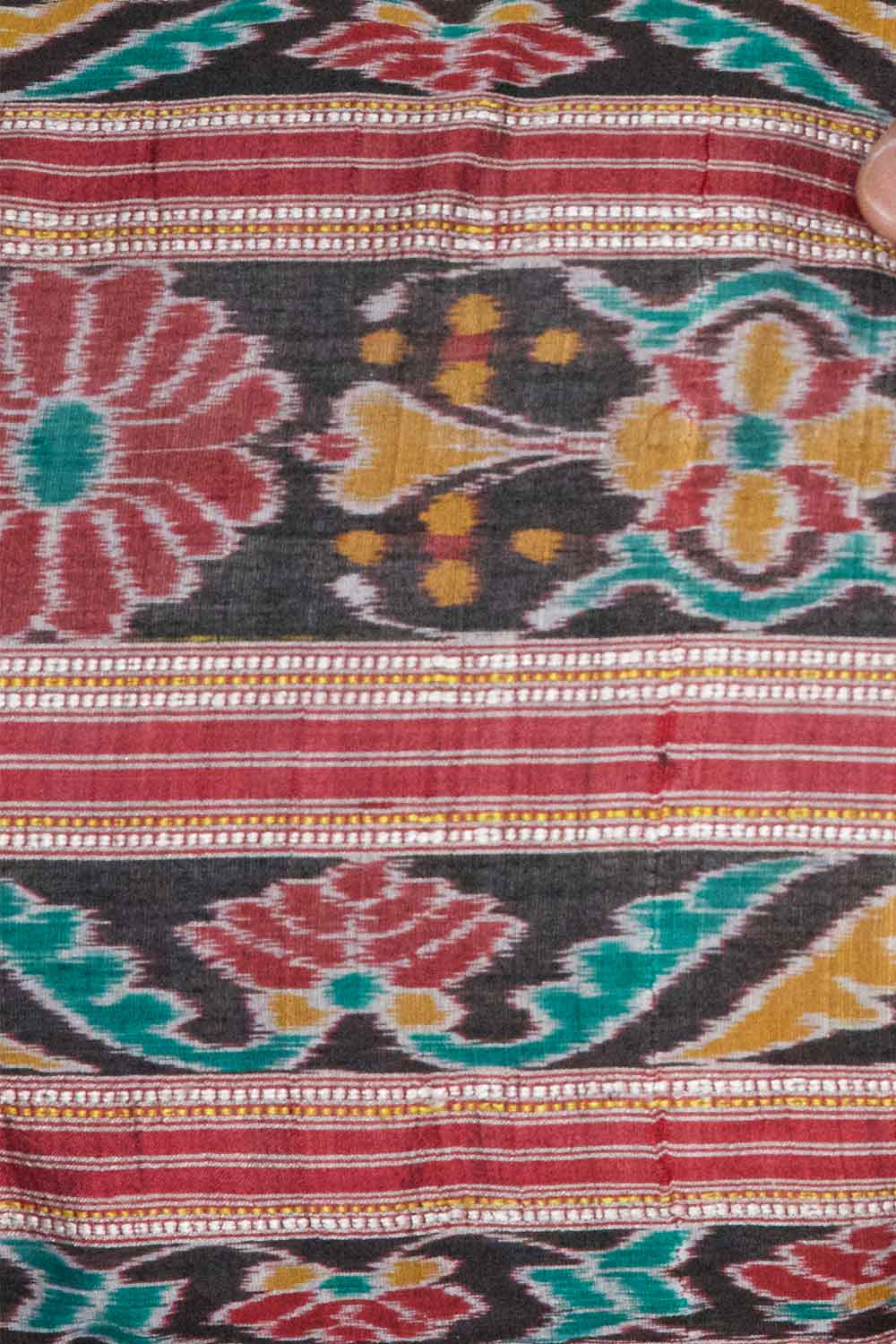 A unique lumbar pillow featuring intricate geometric and floral motifs in warm tones of red, teal, yellow, and beige, set against a black background. The handcrafted design offers a rich, bohemian aesthetic with vintage textile craftsmanship.