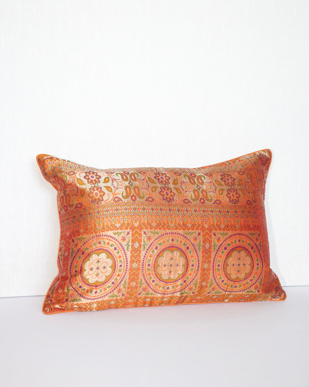 Handwoven 12x20 pillow cover made from luxurious Indian silk brocade, showcasing intricate gold, orange, and pink floral and geometric patterns. A stunning accent piece for any elegant decor.