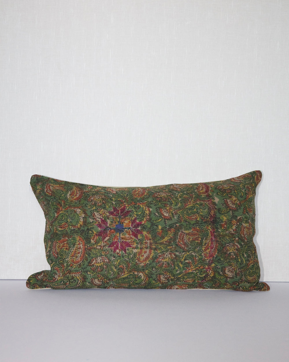 Handcrafted vintage Kantha pillow featuring a green floral block print design, adding bohemian and rustic charm to any room. The rectangular cushion is made from repurposed fabrics, reflecting traditional Indian craftsmanship