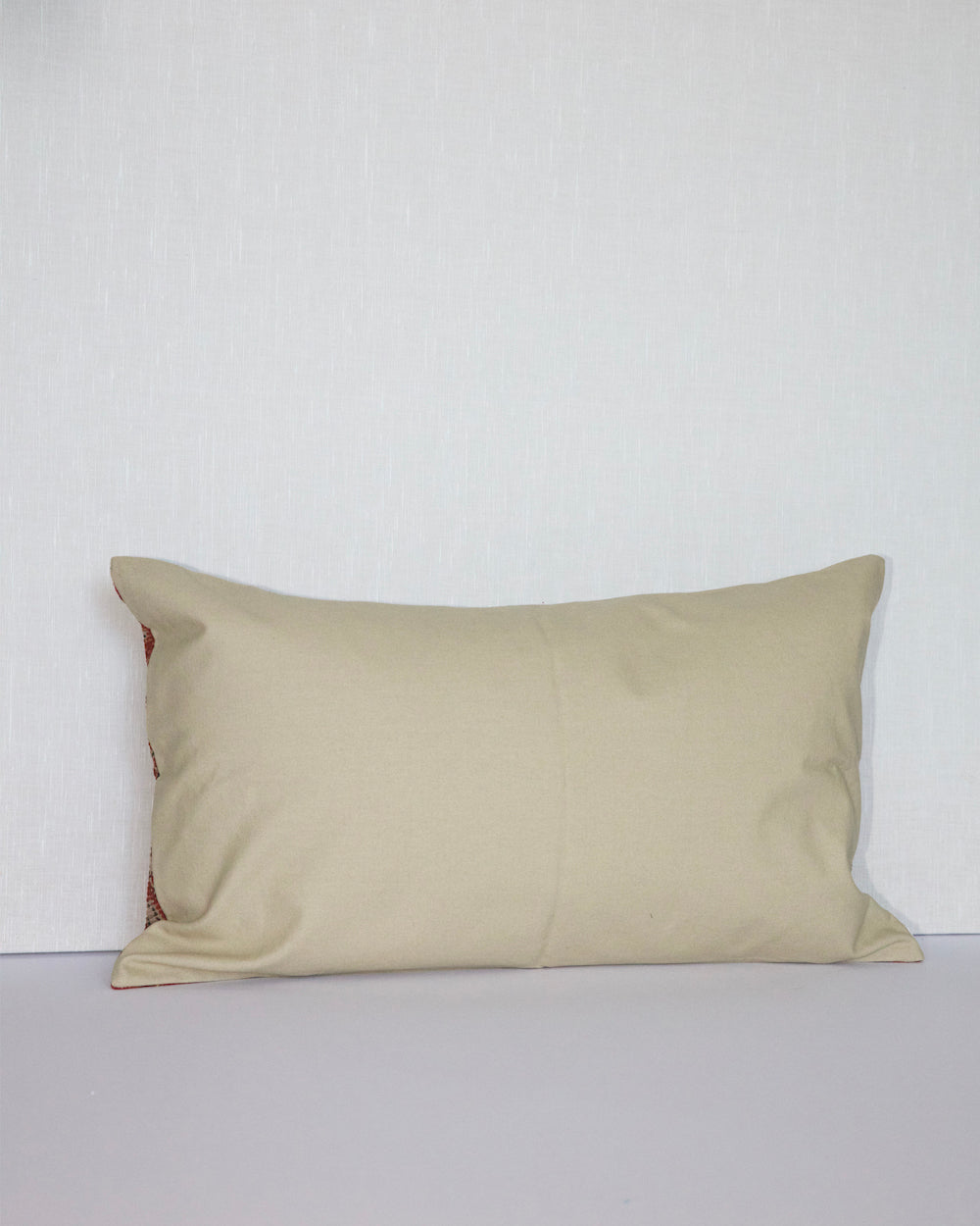 Handcrafted vintage Kantha pillow featuring a rust floral block print design, adding bohemian and rustic charm to any room. The rectangular cushion is made from repurposed fabrics, reflecting traditional Indian craftsmanship