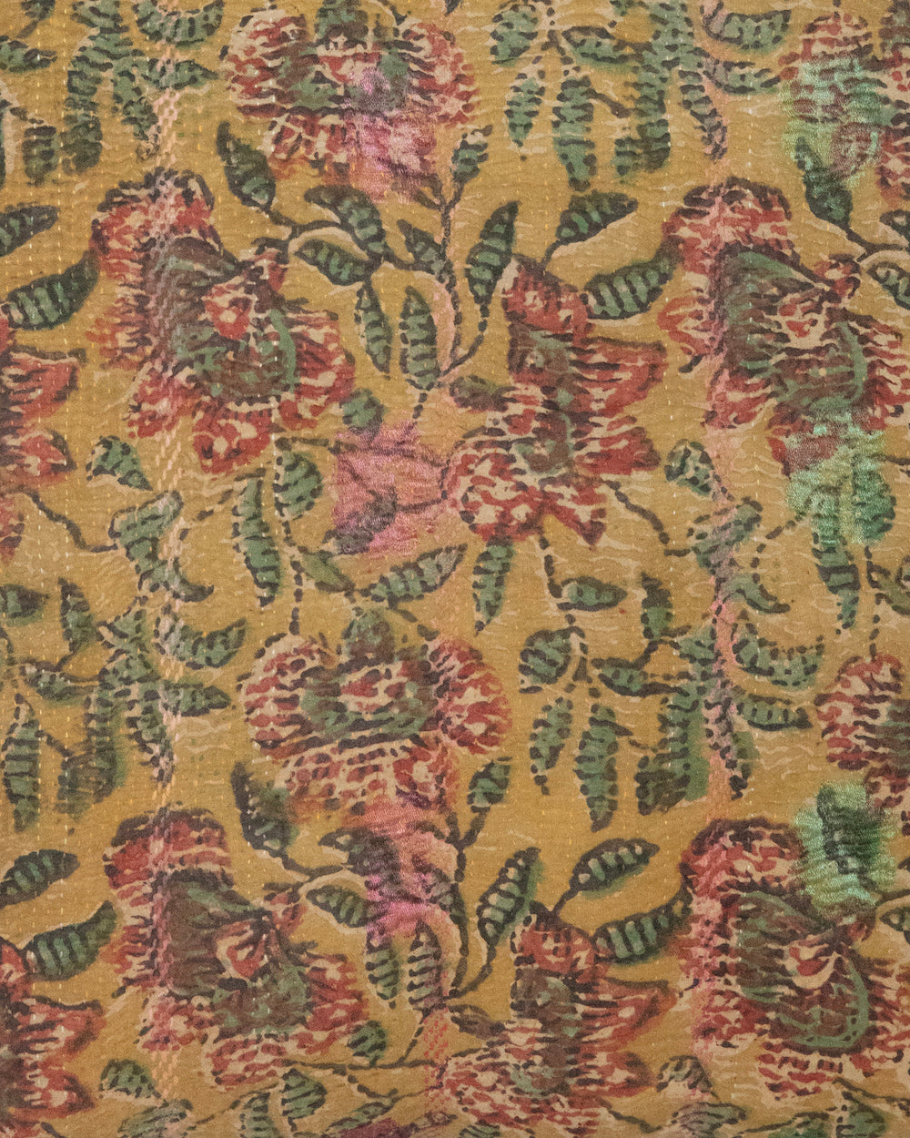 Close up of Daffodil Vintage Kantha Cushion Cover with traditional Bagru block print in earthy yellow tones, showcasing intricate hand-stitched patterns, displayed on a white background.