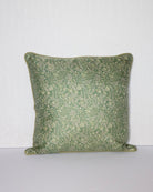 A handcrafted 18x18 pillow cover in a soft green shade, featuring delicate floral and vine patterns in a subtle cream color. The intricate detailing and smooth fabric give the cushion an elegant, nature-inspired look.