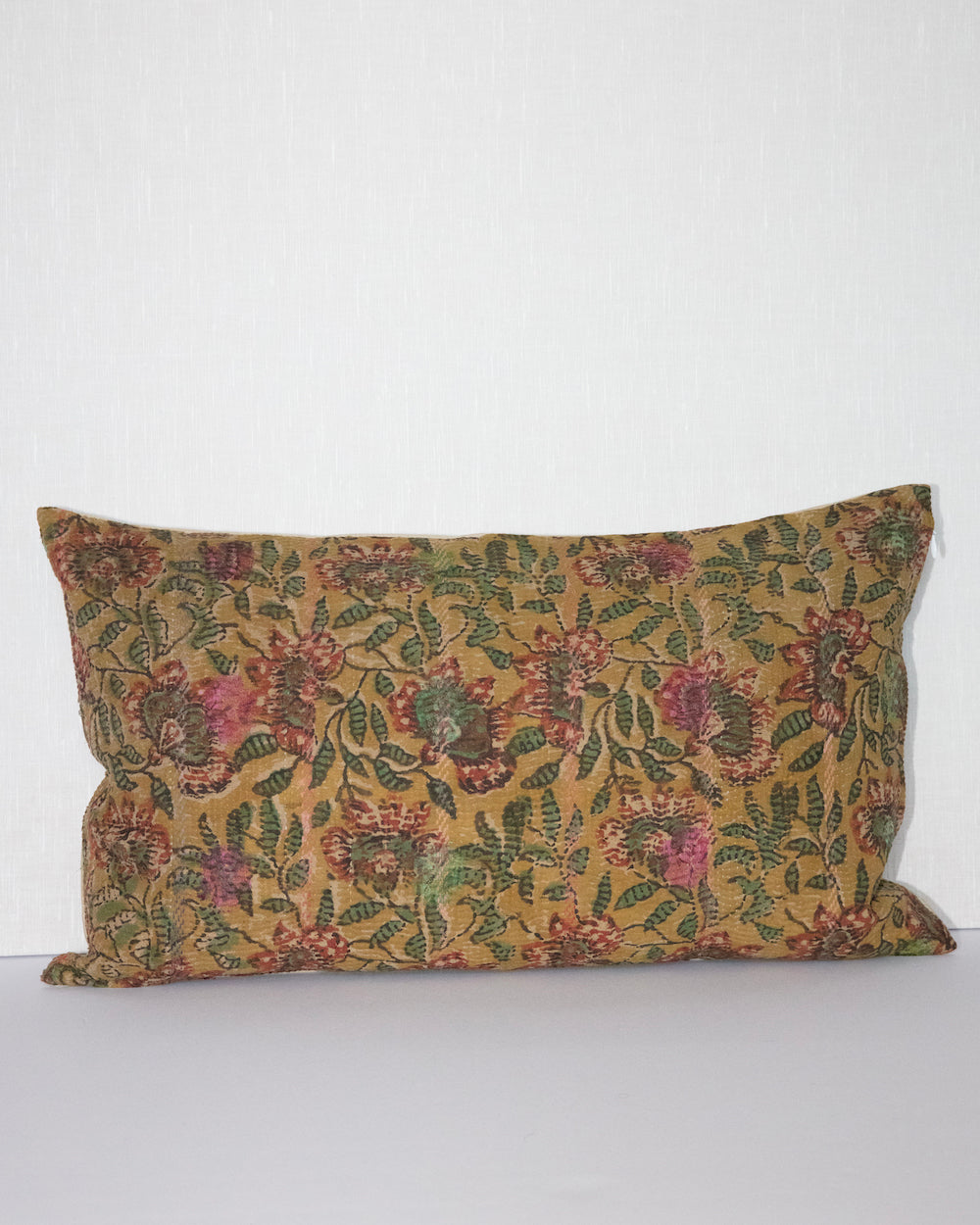Handcrafted vintage Kantha pillow featuring a ochre and rust floral block print design, adding bohemian and rustic charm to any room. The rectangular cushion is made from repurposed fabrics, reflecting traditional Indian craftsmanship