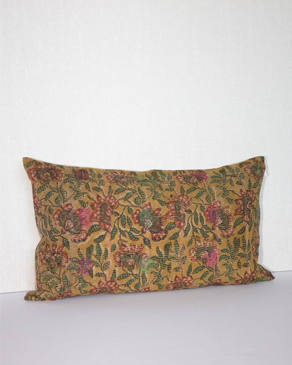 Handcrafted vintage Kantha pillow featuring a ochre and rust floral block print design, adding bohemian and rustic charm to any room. The rectangular cushion is made from repurposed fabrics, reflecting traditional Indian craftsmanship