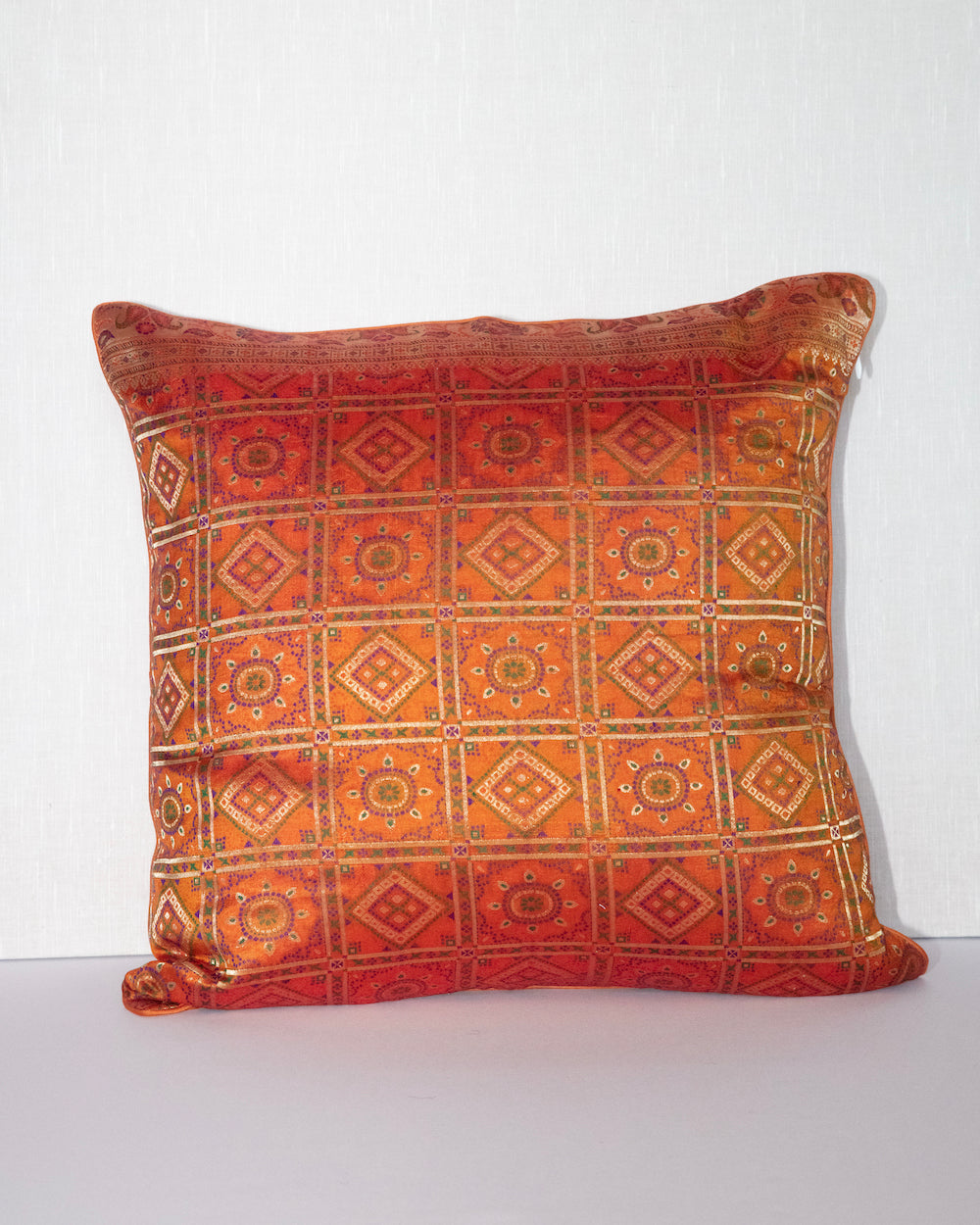 Handwoven 12x20 pillow cover made from luxurious Indian silk brocade, showcasing intricate gold, orange, and pink floral and geometric patterns. A stunning accent piece for any elegant decor.