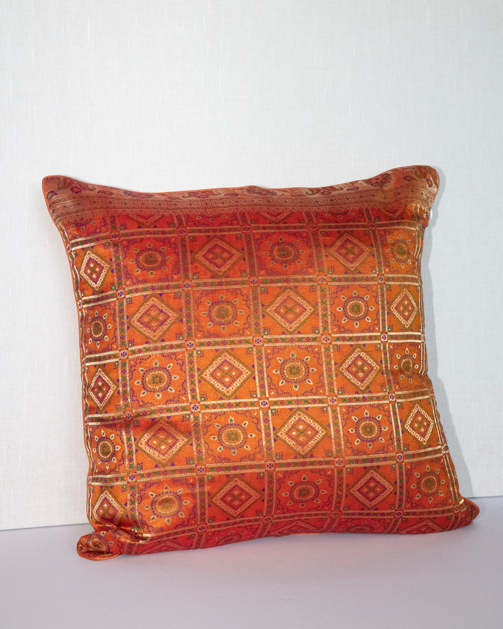 Handwoven 12x20 pillow cover made from luxurious Indian silk brocade, showcasing intricate gold, orange, and pink floral and geometric patterns. A stunning accent piece for any elegant decor.
