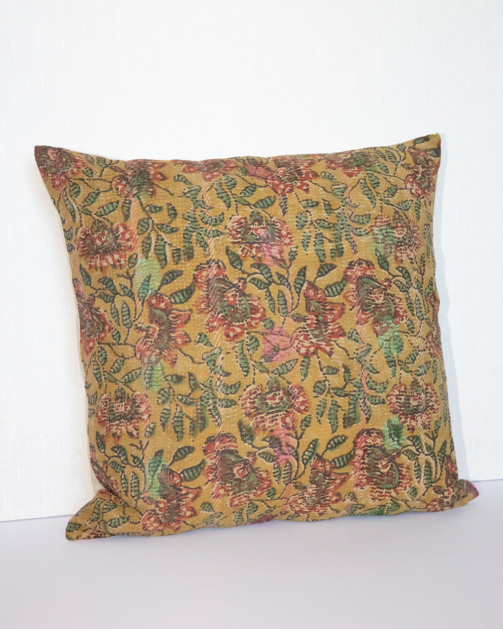 Daffodil Vintage Kantha Cushion Cover with traditional Bagru block print in earthy yellow tones, showcasing intricate hand-stitched patterns, displayed on a white background.