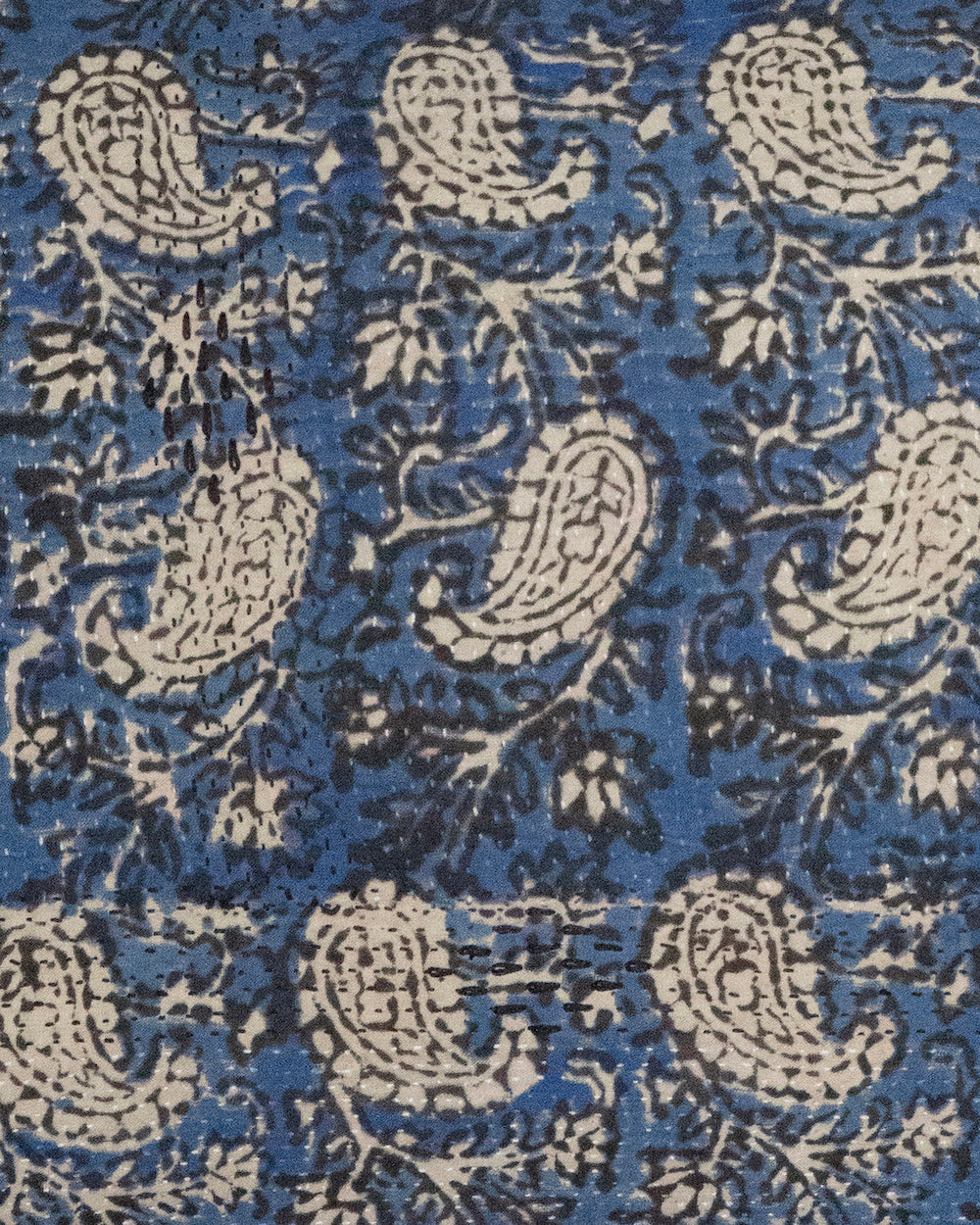 Handcrafted vintage Kantha pillow featuring a indigo paisley block print design, adding bohemian and rustic charm to any room. The rectangular cushion is made from repurposed fabrics, reflecting traditional Indian craftsmanship